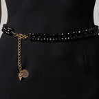 Model wearing the handmade LUMI black crystal waist belt with elegant gold-tone details.