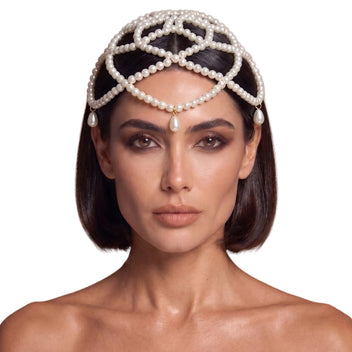 Model wearing the Aurelia ivory pearl headpiece, layered strands framing the face