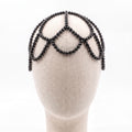 Handmade black crystal headpiece displayed on a mannequin showcasing its elegant draped silhouette.