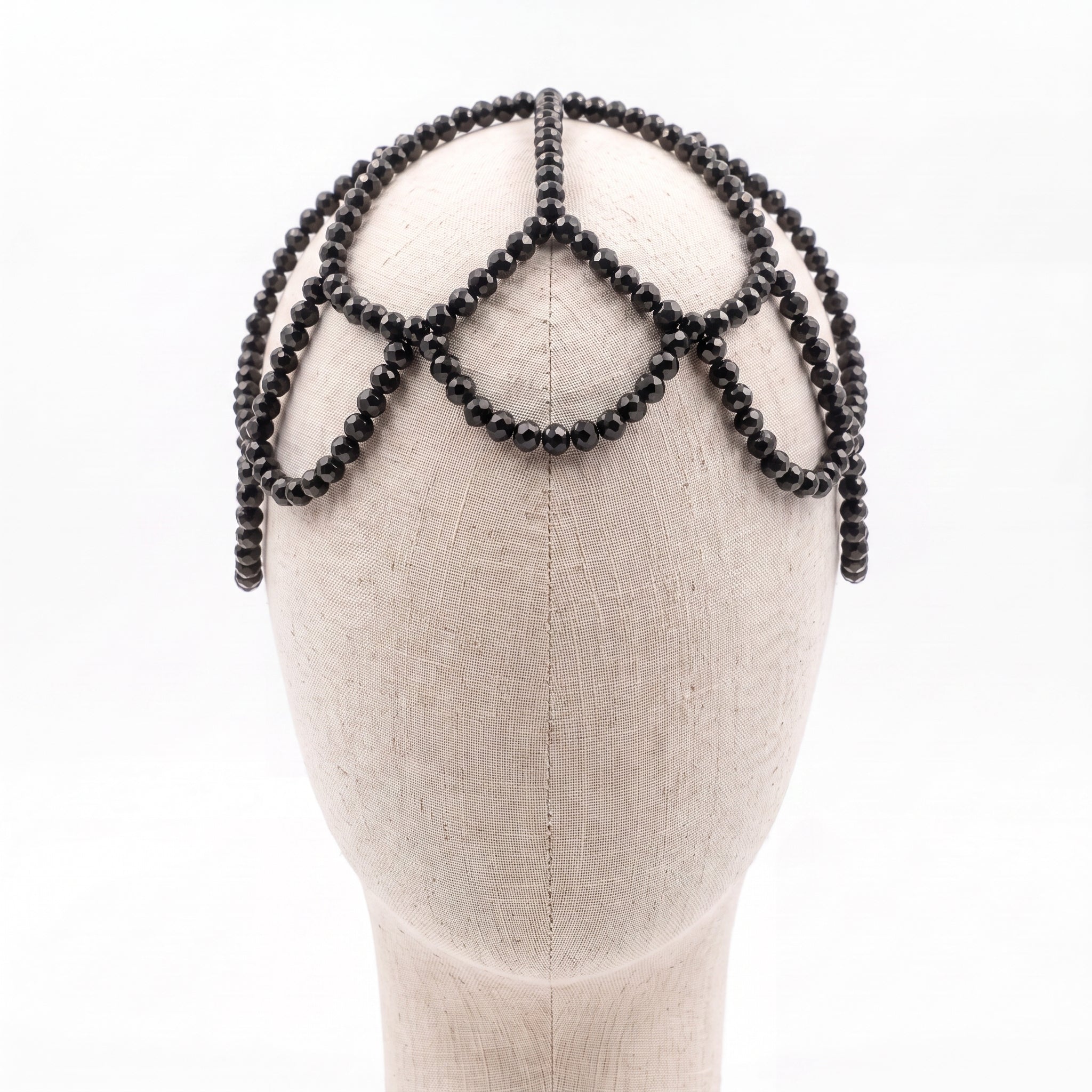Handmade black crystal headpiece displayed on a mannequin showcasing its elegant draped silhouette.