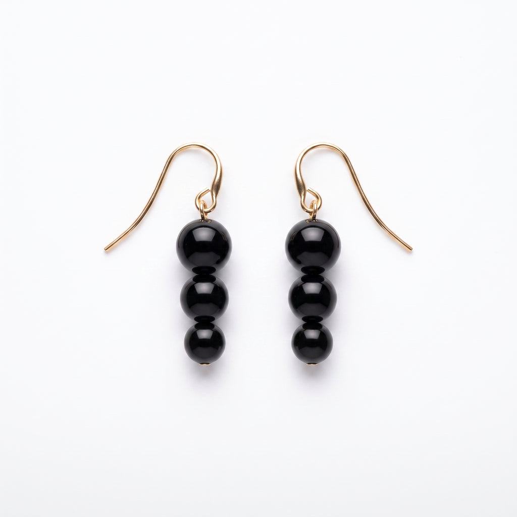 Matching black bead drop earrings from the LUMI The Noir Cascade Jewelry Set on a white background