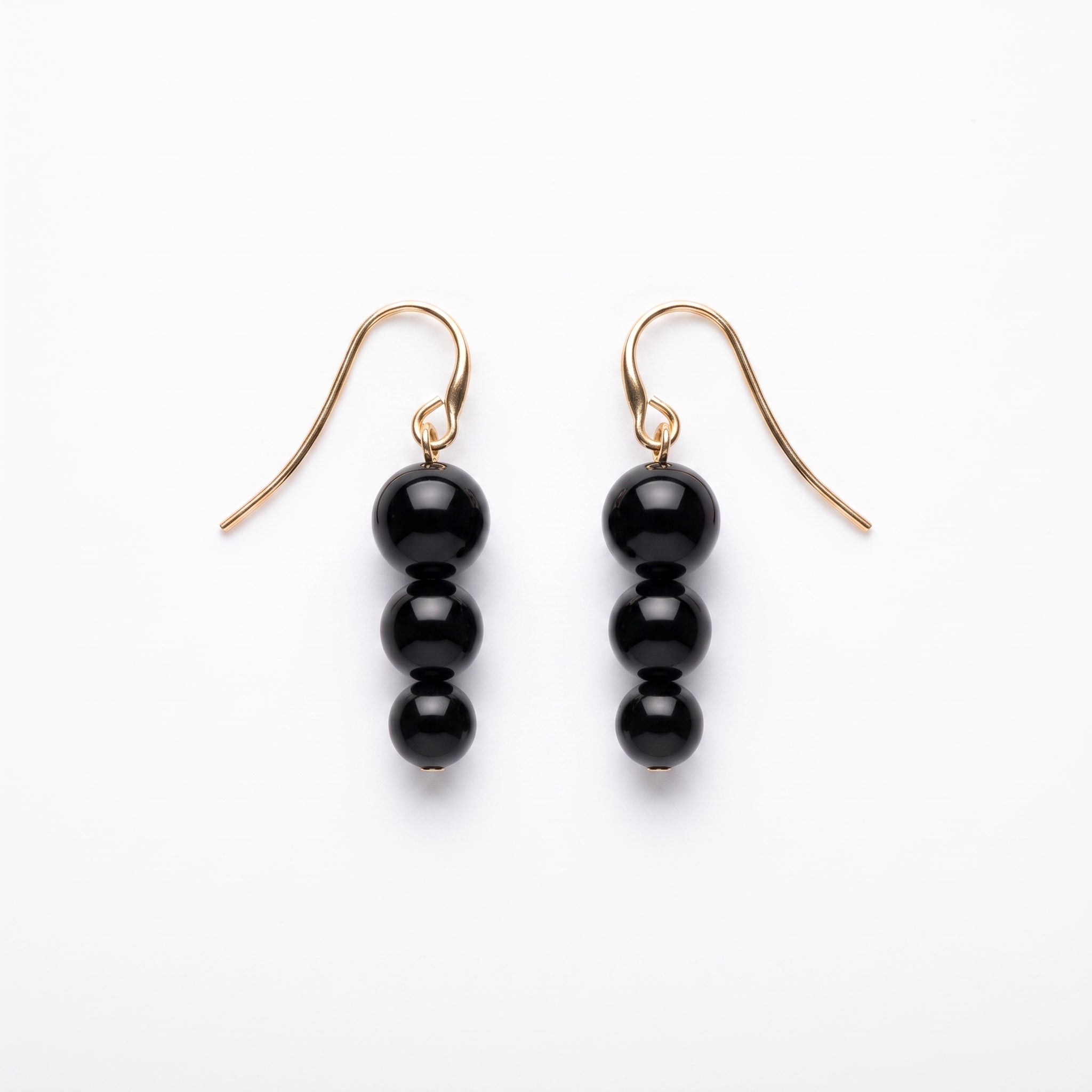 Matching black bead drop earrings from the LUMI The Noir Cascade Jewelry Set on a white background