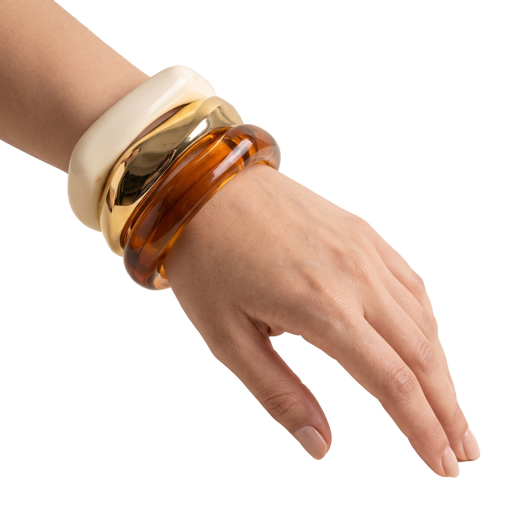 LUMI Natural Luxe Three-Piece Bangle Bracelet Set styled on the wrist with ivory, gold, and amber resin bangles
