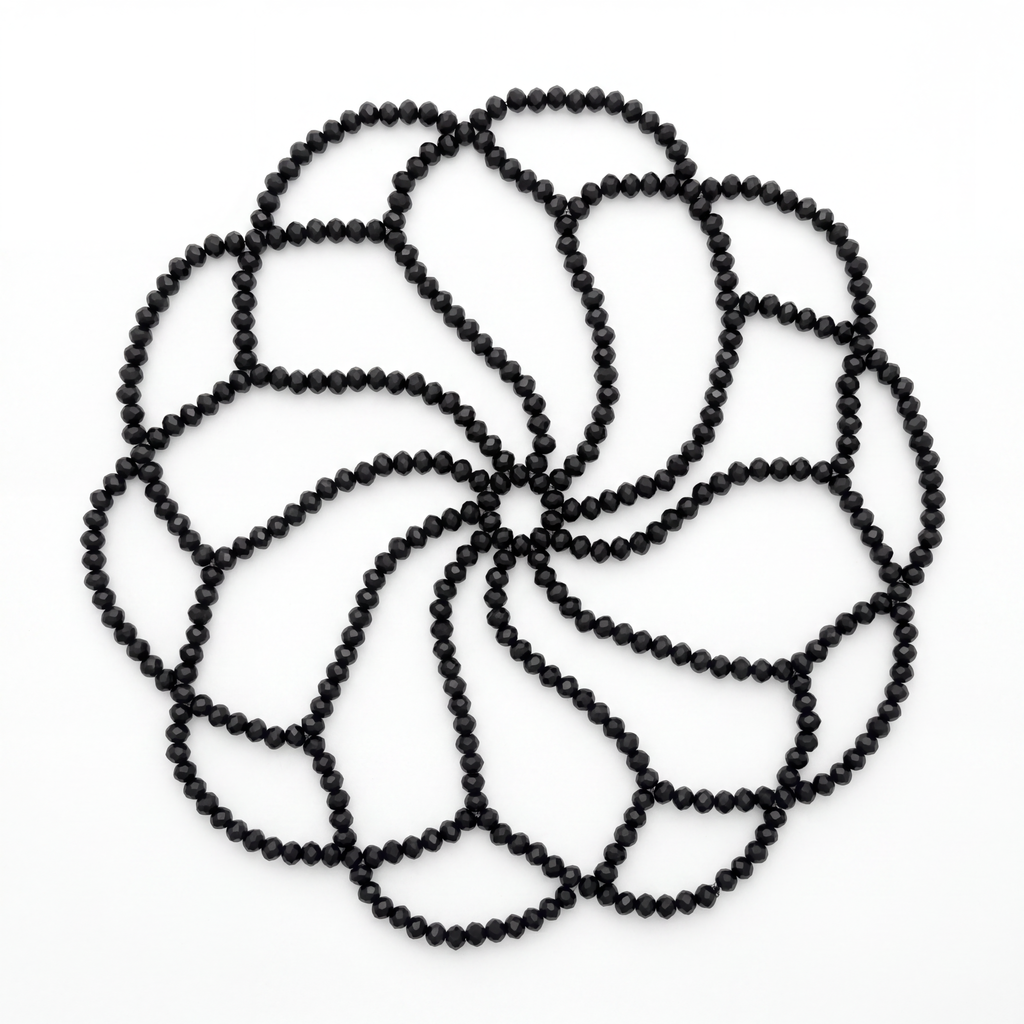 Handmade black crystal headpiece laid flat highlighting its intricate handcrafted bead design.