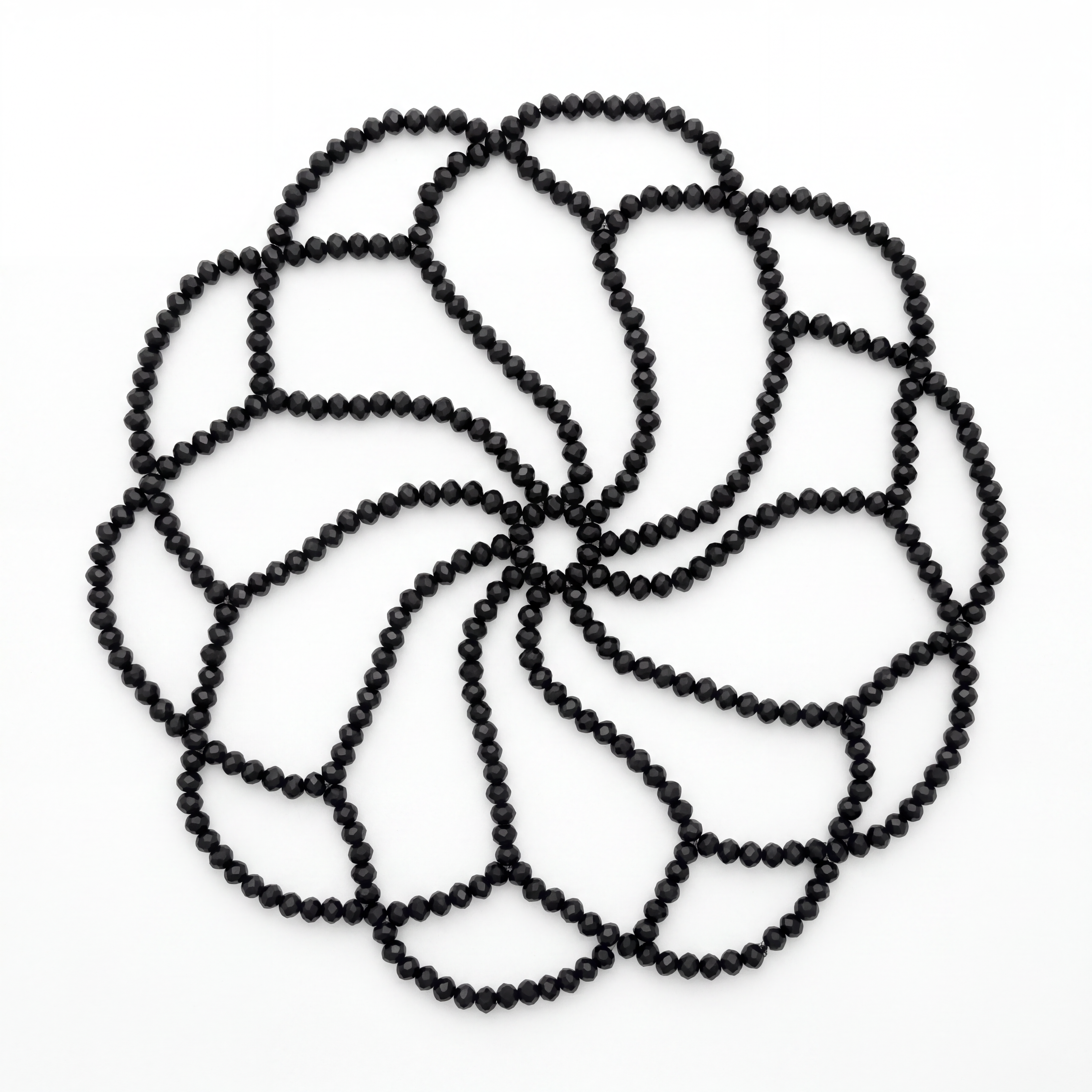 Handmade black crystal headpiece laid flat highlighting its intricate handcrafted bead design.