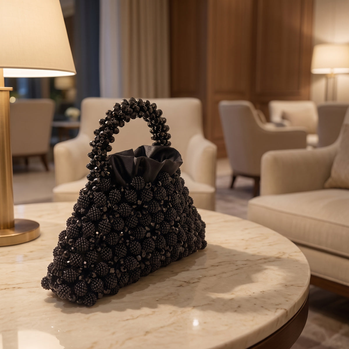 Velvet Caviar black crystal bag on a marble table