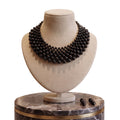 LUMI The Noir Cascade Jewelry Set displayed on a jewelry bust with matching earrings