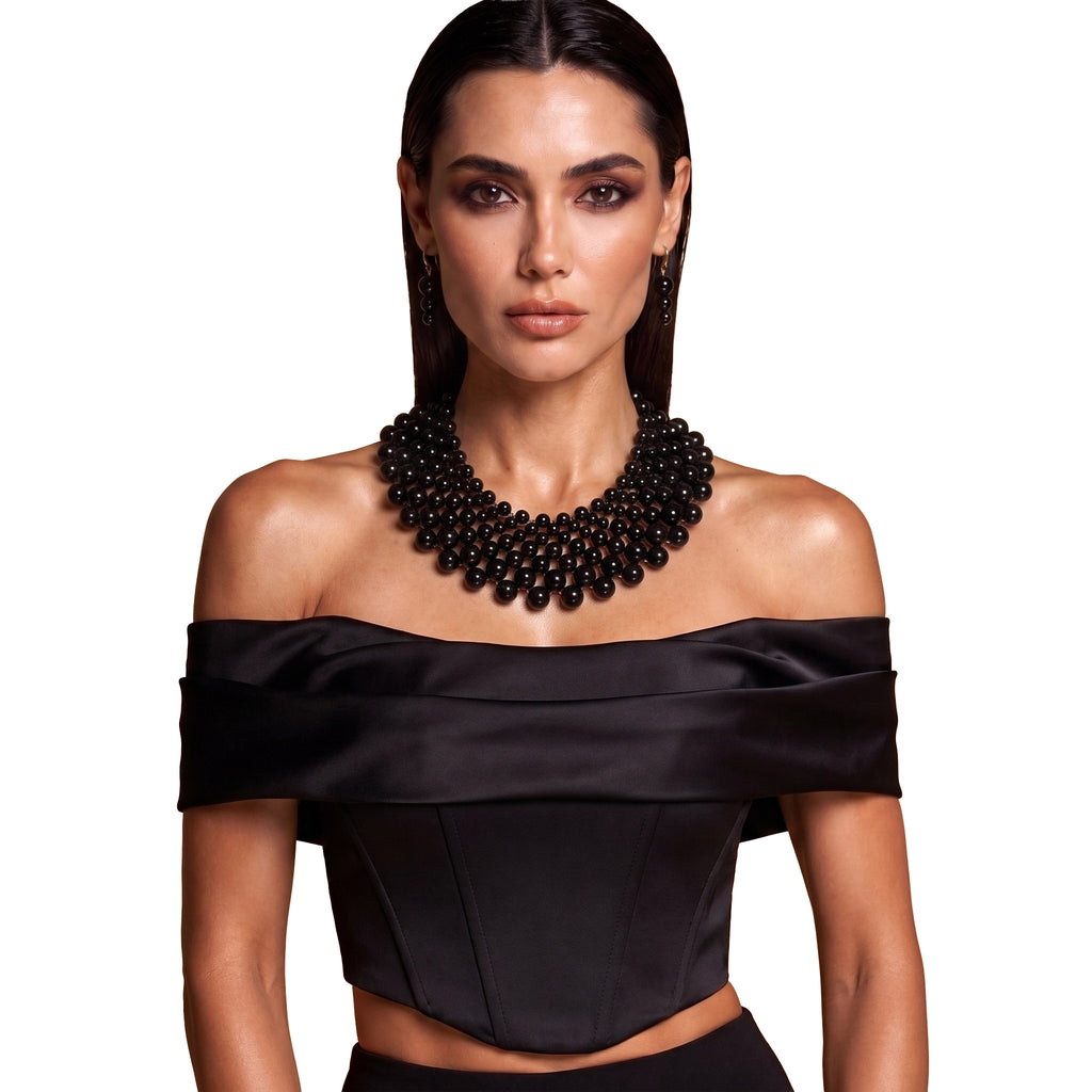 Model wearing the LUMI The Noir Cascade Jewelry Set styled with an elegant black outfit