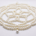 Close-up of the Aurelia ivory pearl headpiece, woven pearl lattice and teardrop details