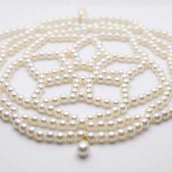 Close-up of the Aurelia ivory pearl headpiece, woven pearl lattice and teardrop details