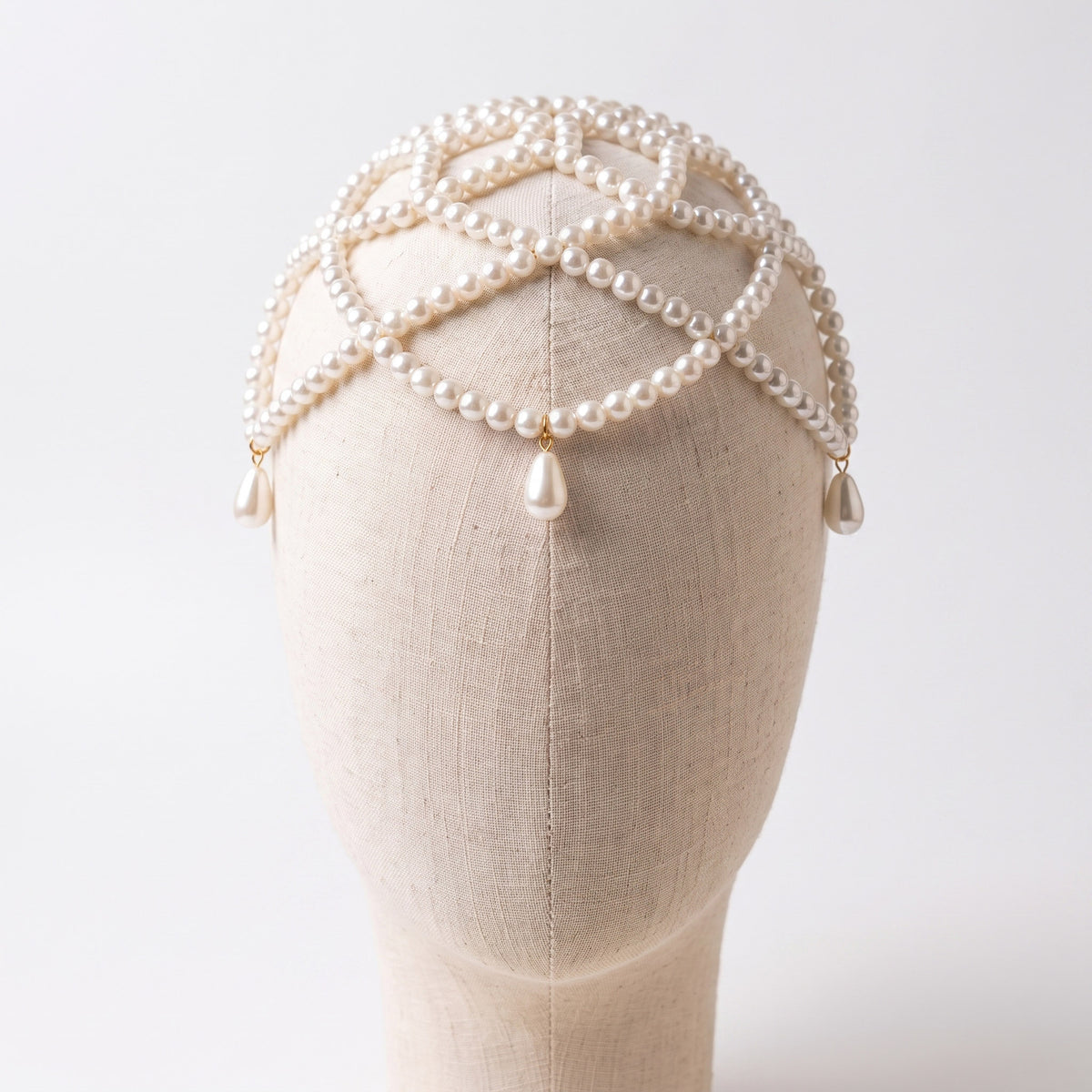 Aurelia ivory pearl headpiece on a mannequin, layered strands and teardrop accents