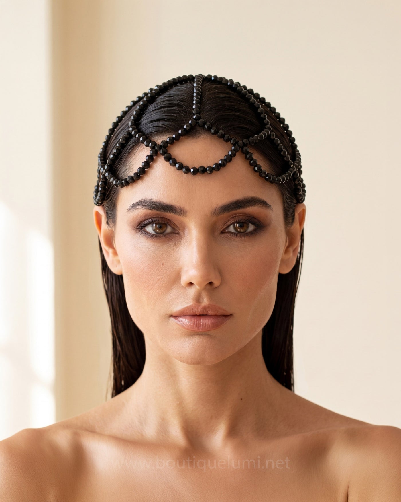 Model wearing a black crystal headpiece showcasing LUMI luxury body jewelry collection.