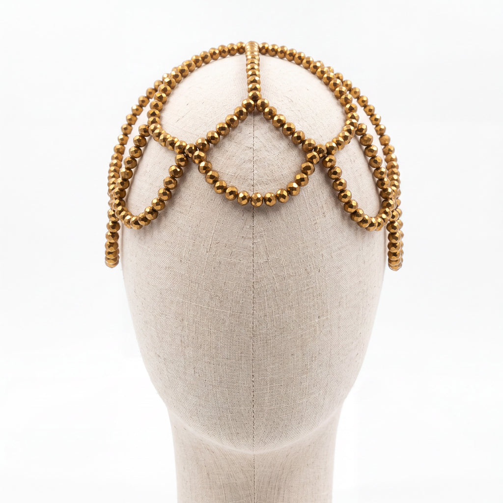 Gold crystal handmade headpiece displayed on a mannequin highlighting its crown-inspired silhouette.