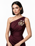 Woman wearing the handmade Astra Pearl Burst Brooch with white pearls and gold-tone detailing by LUMI.
