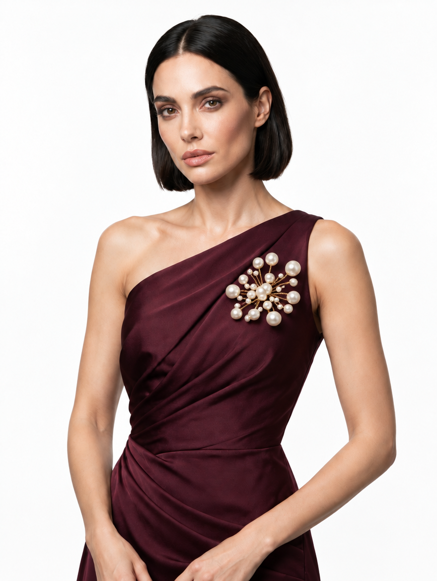 Woman wearing the handmade Astra Pearl Burst Brooch with white pearls and gold-tone detailing by LUMI.