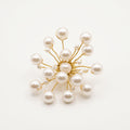 Handmade Astra Pearl Burst Brooch by LUMI with white pearl beads arranged on sculptural gold-tone branches.