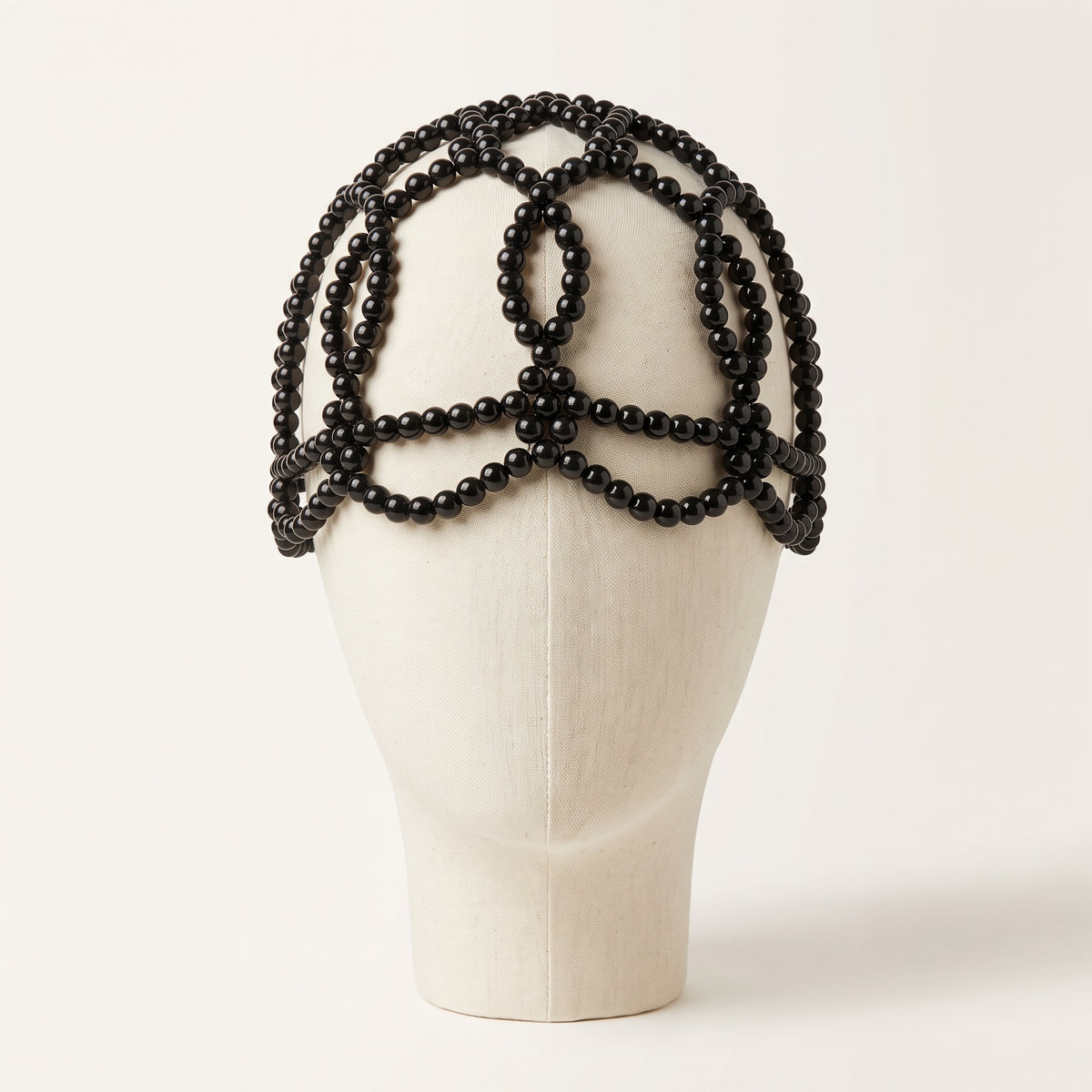 Aurelia Noir black pearl headpiece front view on ivory mannequin