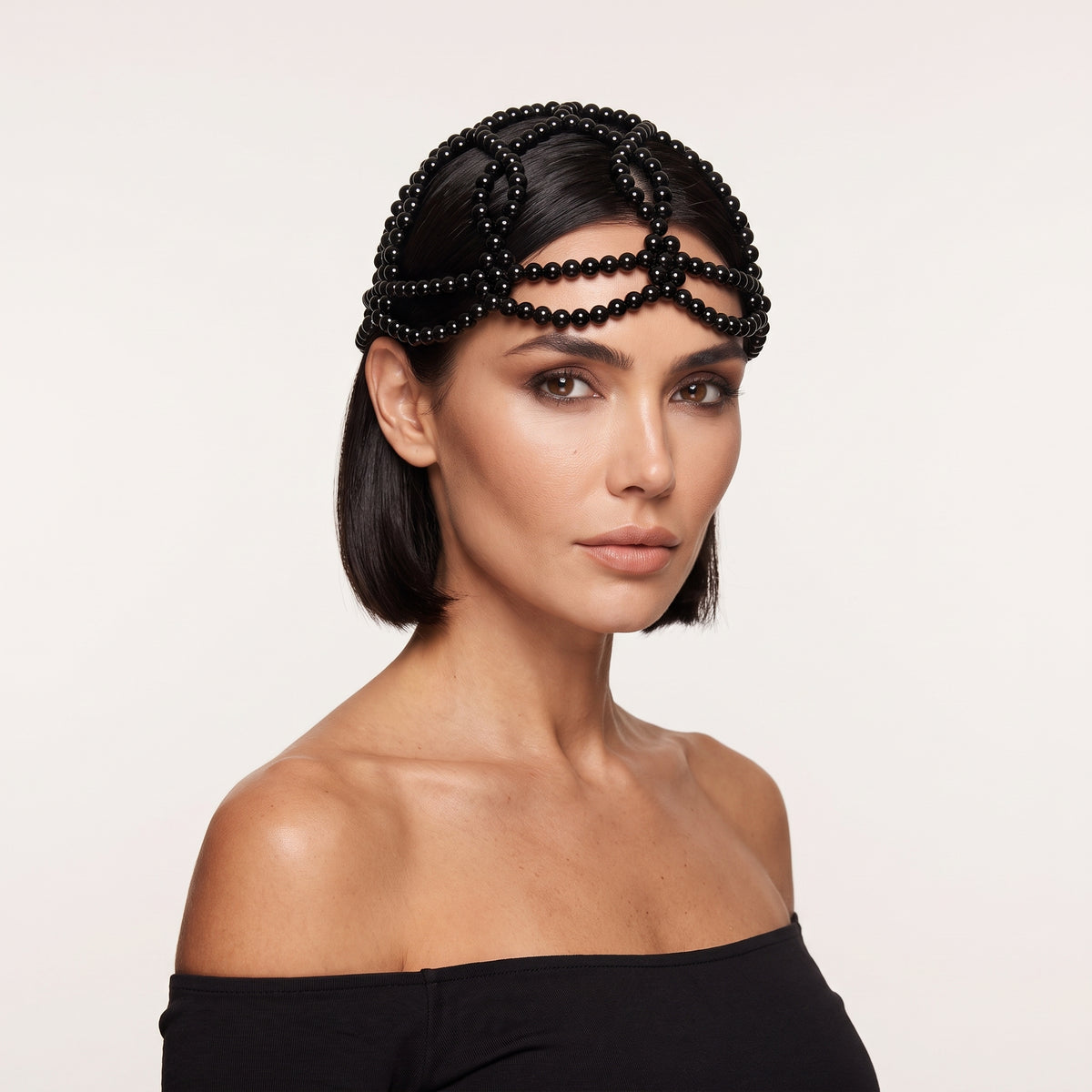 Woman wearing Aurelia Noir black pearl headpiece by LUMI