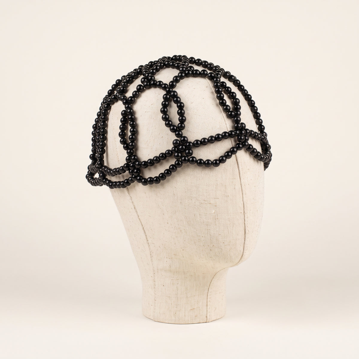 Aurelia Noir black pearl headpiece side angle showing sculptural pearl detailing