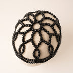 Top detail of Aurelia Noir black pearl headpiece lattice design