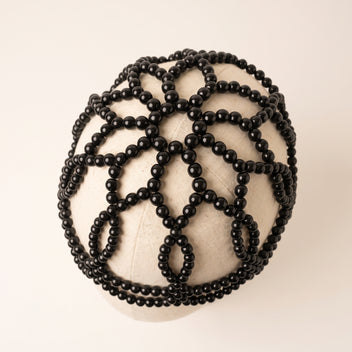 Top detail of Aurelia Noir black pearl headpiece lattice design