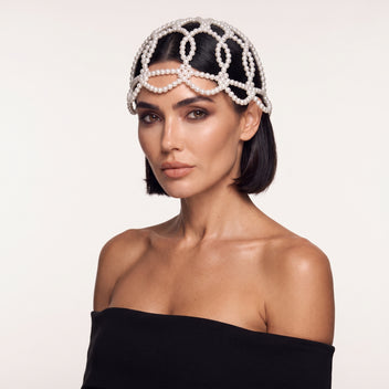 Woman wearing the handmade Aurelia White Pearl Headpiece by LUMI.