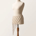 Angled view of the handmade Celeste white pearl waist belt showing its asymmetric cascading lattice design.