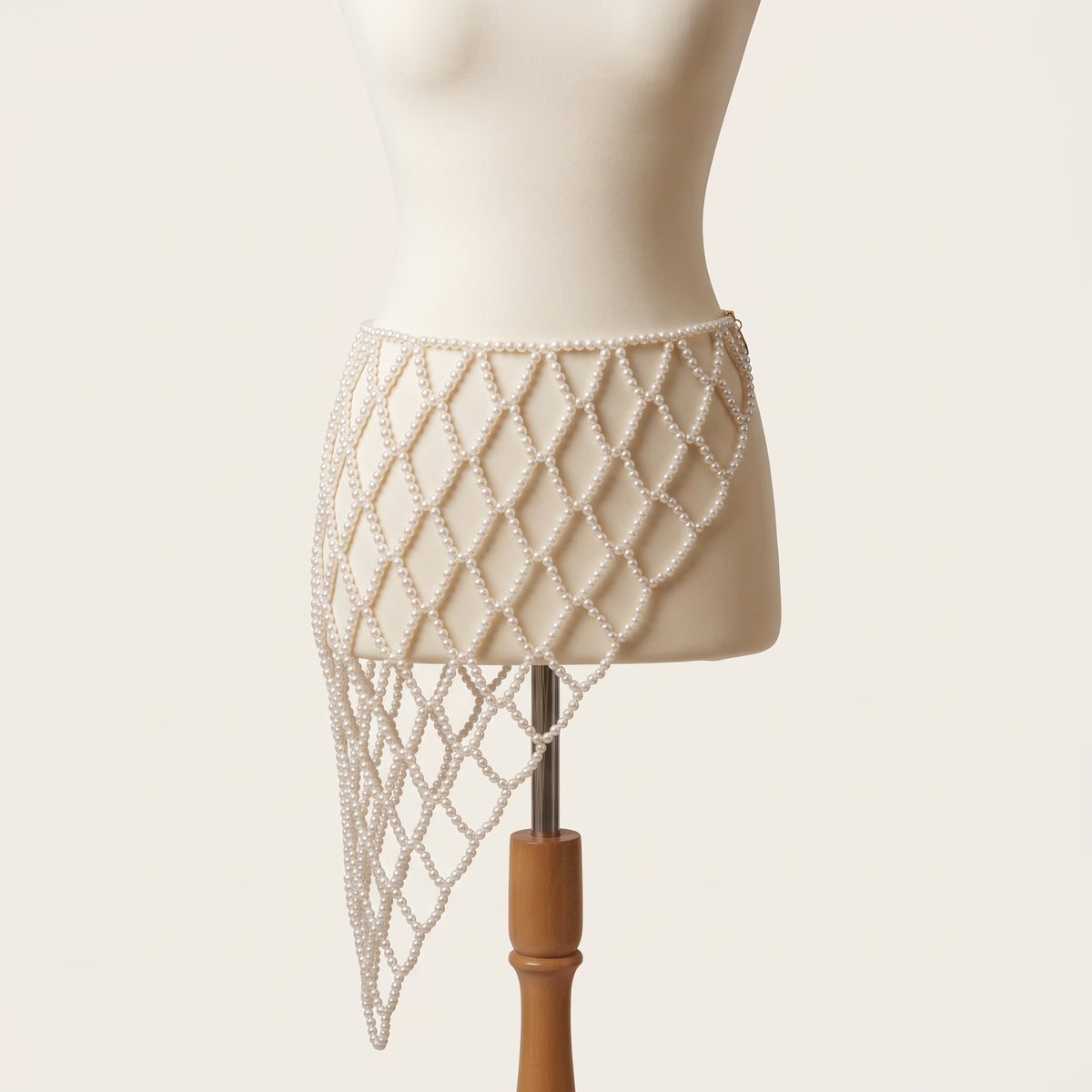 Front view of the adjustable Celeste Pearl Lattice Belt displayed on an ivory mannequin.