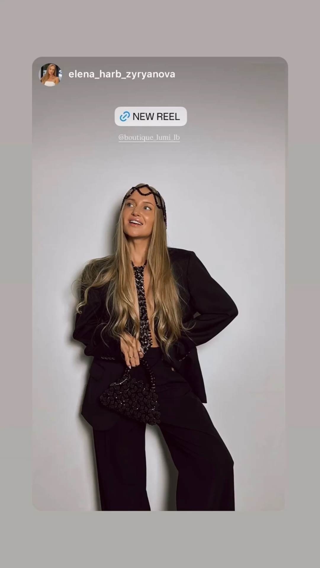 Elena Harb wearing LUMI statement accessories with a black tailored suit.