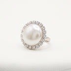 Handmade Celestia Pearl Halo Ring – White by LUMI, featuring a large white pearl surrounded by clear glass crystals in a polished silver-tone metal setting against a white background.