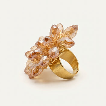 Angled view of the handmade Champagne Crystal Bloom Ring by LUMI, showcasing its dimensional floral crystal arrangement and gold-tone adjustable ring band.