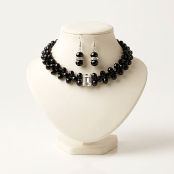 Handmade Éclipse Crystal Choker Jewelry Set – Noir by LUMI, featuring a black glass crystal necklace with a rectangular clear crystal centerpiece and matching silver-tone drop earrings displayed on an ivory jewelry bust.