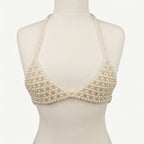 Front view of LUMI's handmade ivory pearl bra top, featuring triangular pearl-beaded cups, delicate halter straps and matching underbust bands.
