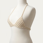 Handmade ivory pearl bra top by LUMI, shown on a white mannequin in a three-quarter studio view, highlighting the beaded cups and pearl straps.