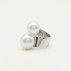 Angled view of the handmade Solène Double Pearl Ring by LUMI, featuring two large white pearls arranged on an open-style adjustable silver-tone metal band.