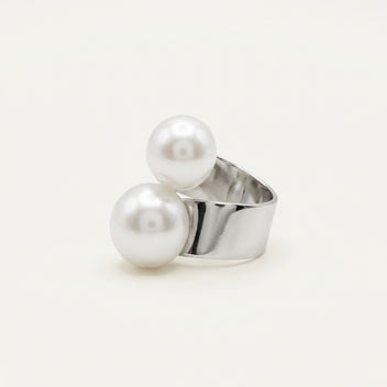 Angled view of the handmade Solène Double Pearl Ring by LUMI, featuring two large white pearls arranged on an open-style adjustable silver-tone metal band.
