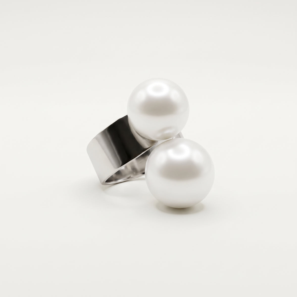 Detailed studio photograph of LUMI's Solène Double Pearl Ring – White, highlighting the smooth round pearl accents and reflective polished silver-tone metal band.