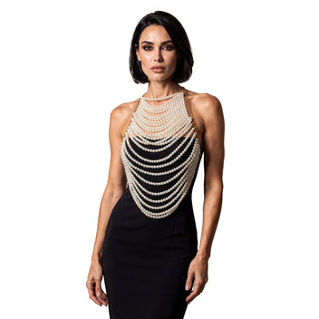 Woman wearing the Aurelia pearl body top, layered ivory pearls and gold-tone chain