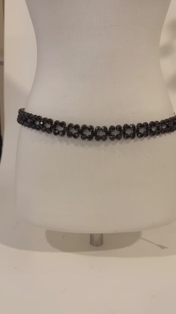 Video of the handmade Noir Crystal Belt by LUMI showing the faceted black crystal beadwork, adjustable fit and gold-tone chain details from multiple angles.
