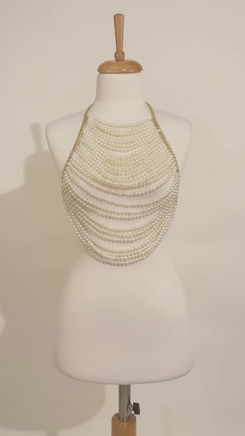 LUMI handmade pearl body top displayed on a mannequin, featuring cascading ivory pearl strands and an elegant draped design.