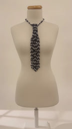 Video of the Cravate de Lumière by LUMI showing the black and silver crystal necktie, adjustable chain and light-catching beadwork from multiple angles.