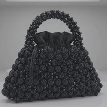 Close-up of the Velvet Caviar bag, crystal bead surface