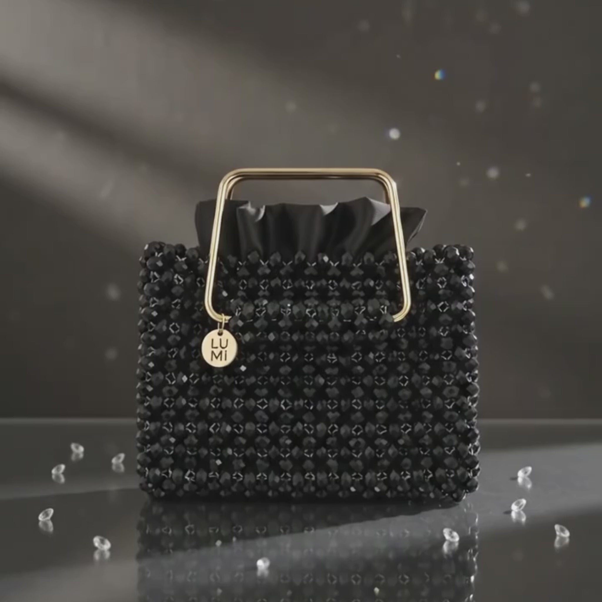 Close-up of the handmade black crystal handbag showing crystal craftsmanship and gold-tone handle.