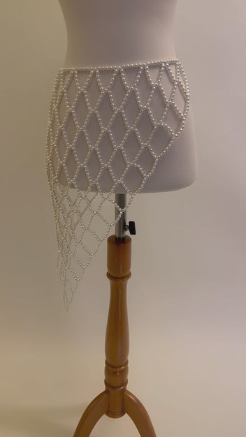 Video of the handmade Celeste Pearl Lattice Belt showing the adjustable white pearl lattice design, drape and gold-tone clasp by LUMI.