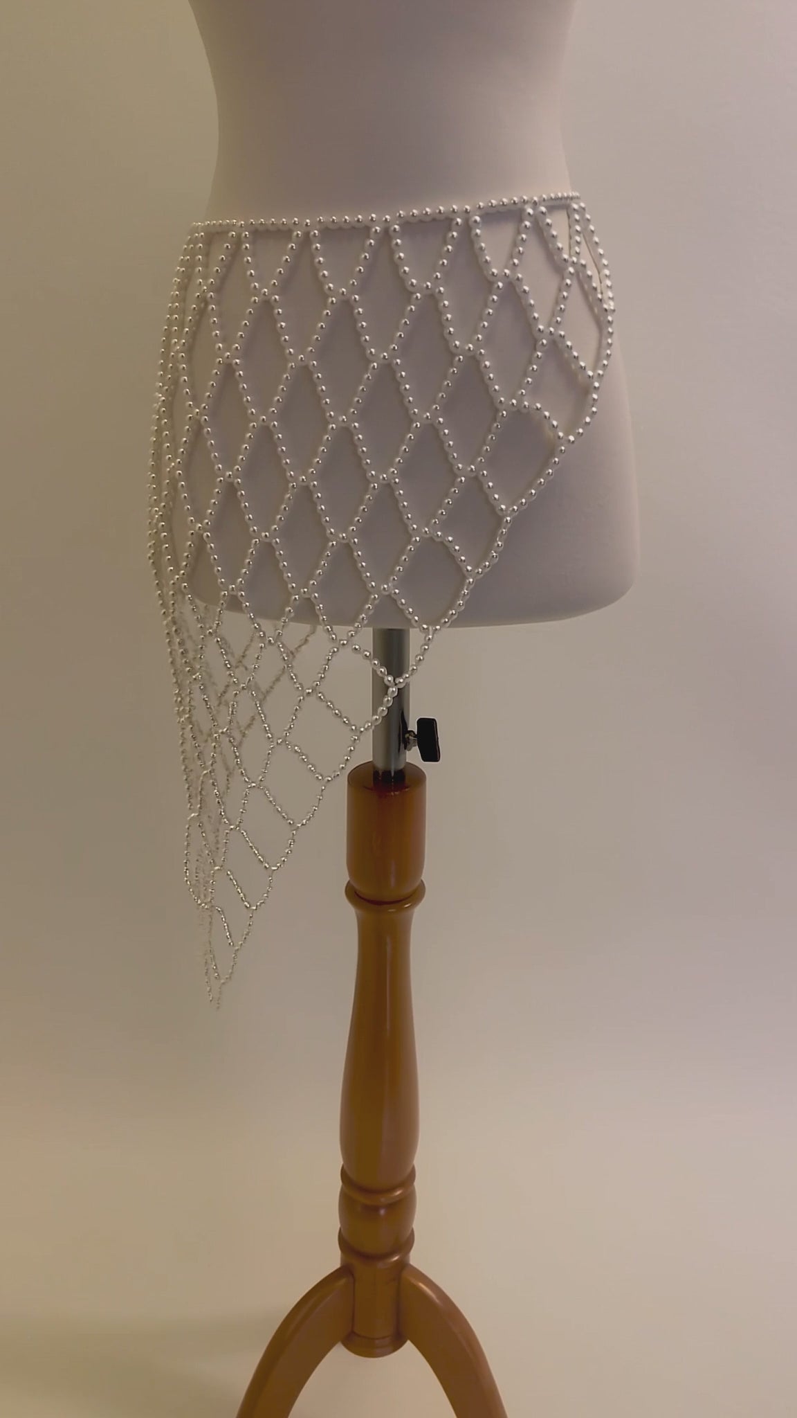 Video of the handmade Celeste Pearl Lattice Belt showing the adjustable white pearl lattice design, drape and gold-tone clasp by LUMI.