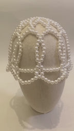 Video of the handmade Aurelia White Pearl Headpiece showing its sculptural white pearl lattice design from multiple angles.