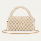 Back view of The Nacre Bag showing the pearl construction, structured silhouette and gold-tone chain strap.