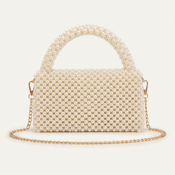 Back view of The Nacre Bag showing the pearl construction, structured silhouette and gold-tone chain strap.