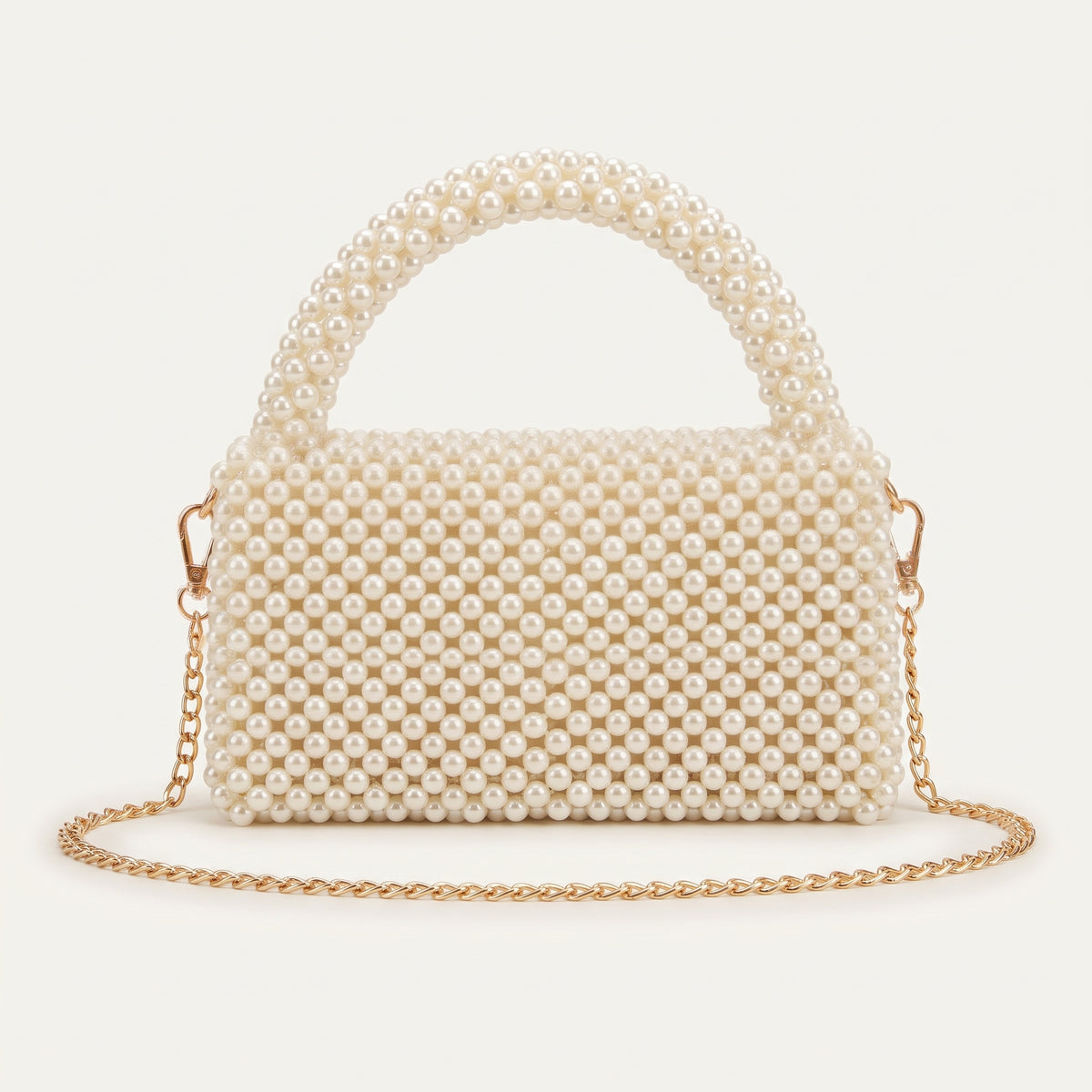 Back view of The Nacre Bag showing the pearl construction, structured silhouette and gold-tone chain strap.